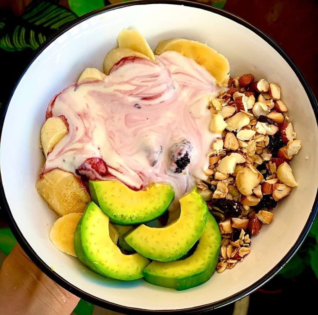 Oatmeal-topped-with-Greek-yogurt-strawberries-banana-avocado-mixed-nuts-and-dried-fruit-e1786706395525